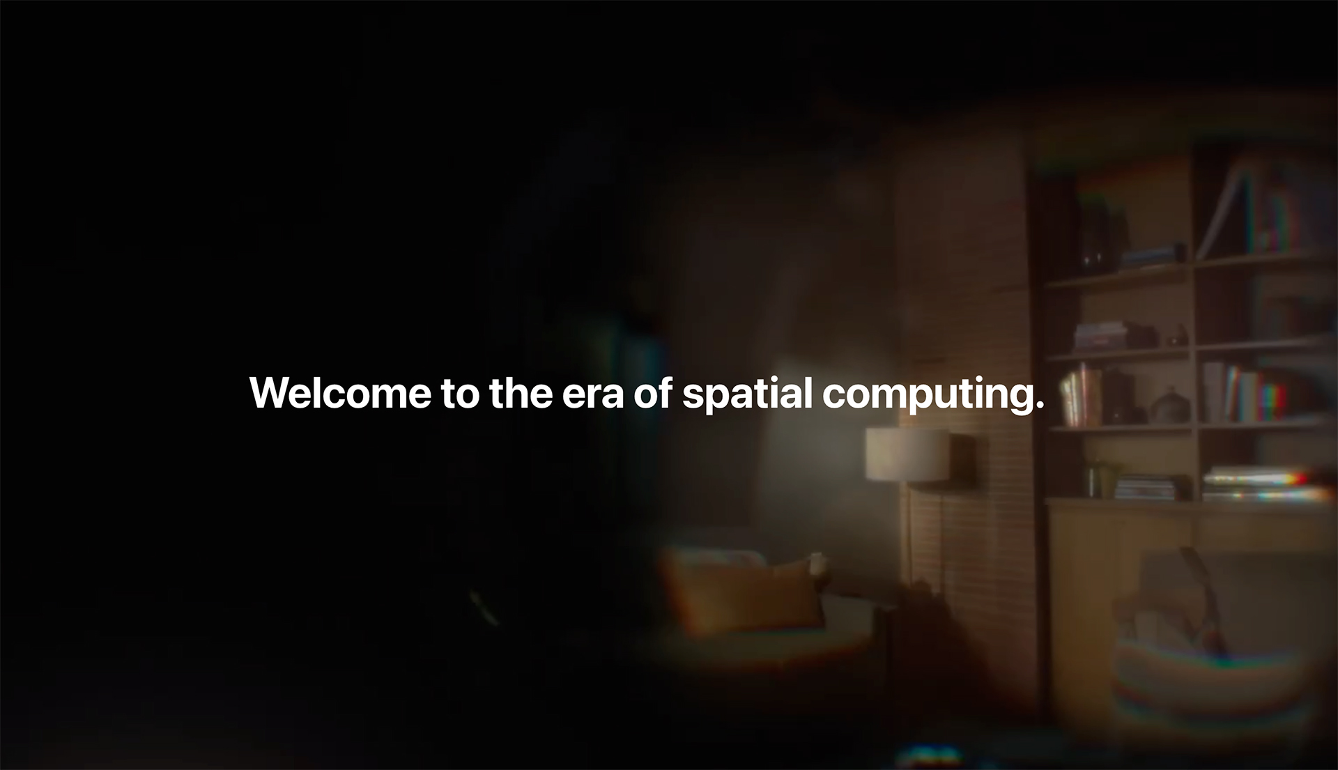 Blurry, immersive view of a cozy living room with the centered text “Welcome to the era of spatial computing,” representing the Apple Vision Pro experience and its introduction to augmented reality.